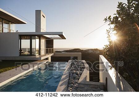 Modern house overlooking beach at sunset View Large Photo Image Stock Image - Modern house overlooking beach at sunset. Fotosearch