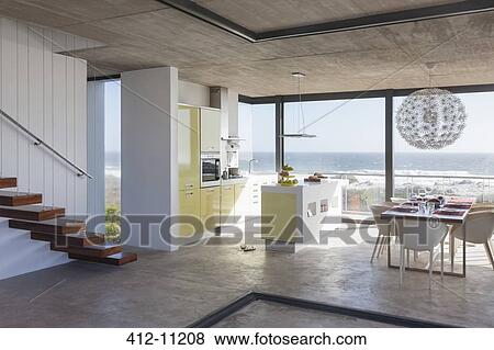 Modern kitchen and dining room overlooking ocean View Large Photo Image Stock Photo - Modern kitchen and dining room overlooking ocean. Fotosearch