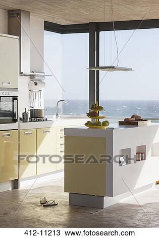 Stock Image - Modern kitchen overlooking ocean. Fotosearch