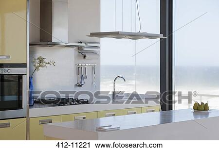 Stock Image - Modern kitchen overlooking ocean. Fotosearch