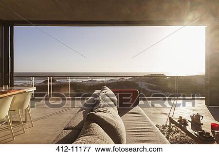 Stock Photo - Modern living room overlooking ocean. Fotosearch