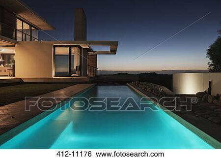 Modern pool illuminated at night View Large Photo Image Stock Photograph - Modern pool illuminated at night. Fotosearch