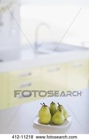 Stock Photo - Plate of pears on kitchen counter. Fotosearch