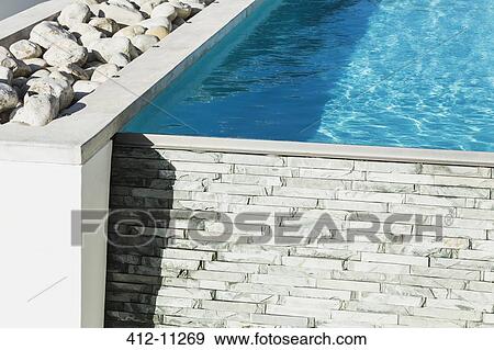 Rocks and wall around lap pool View Large Photo Image Stock Photo - Rocks and wall around lap pool. Fotosearch
