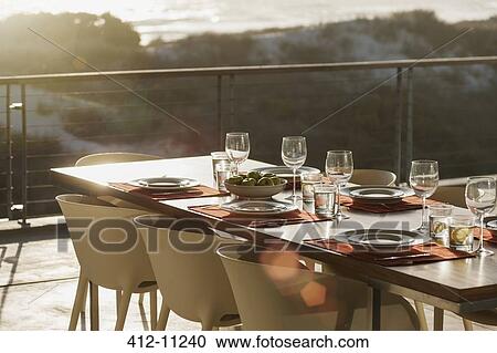 Set table in modern dining room open to balcony View Large Photo Image Stock Image - Set table in modern dining room open to balcony. Fotosearch