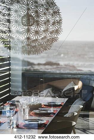Set table in modern dining room overlooking ocean View Large Photo Image Stock Image - Set table in modern dining room overlooking ocean. Fotosearch