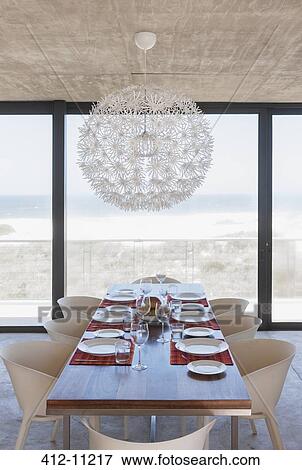 Set table in modern dining room overlooking ocean View Large Photo Image Stock Photo - Set table in modern dining room overlooking ocean. Fotosearch