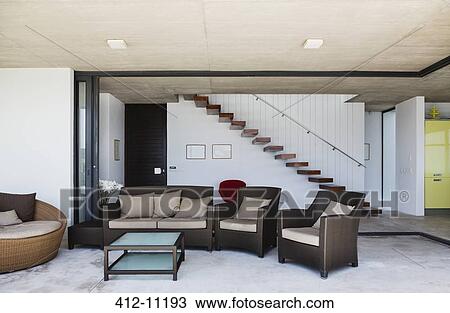 Stock Image - Sofa and armchairs in modern living room. Fotosearch