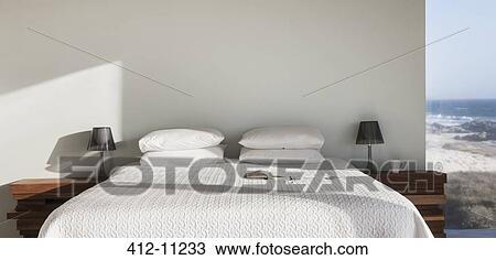 Sun shining on white bed with ocean view View Large Photo Image Stock Image - Sun shining on white bed with ocean view. Fotosearch
