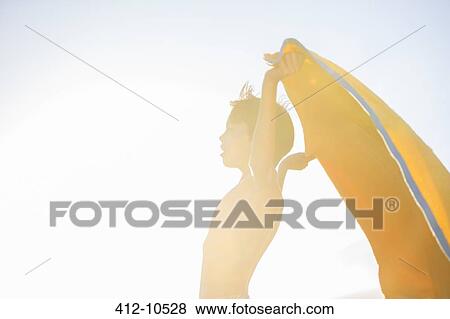 Boy playing with towel on beach View Large Photo Image Stock Photo - Boy playing with towel on beach. Fotosearch