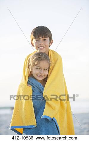 Brother and sister wrapped in towels on beach View Large Photo Image Stock Photograph - Brother and sister wrapped in towels on beach. Fotosearch