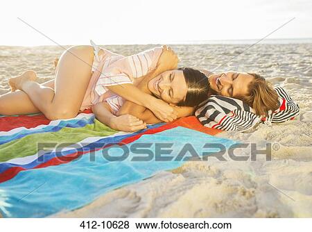 Couple relaxing together on beach View Large Photo Image Stock Photo - Couple relaxing together on beach. Fotosearch