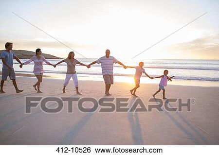 Family holding hands on beach View Large Photo Image Stock Photograph - Family holding hands on beach. Fotosearch