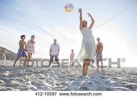 Stock Photo - Family playing together on beach. Fotosearch