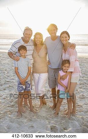 Family smiling together on beach View Large Photo Image Stock Image - Family smiling together on beach. Fotosearch