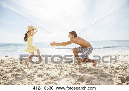 Father and daughter playing on beach View Large Photo Image Stock Image - Father and daughter playing on beach. Fotosearch