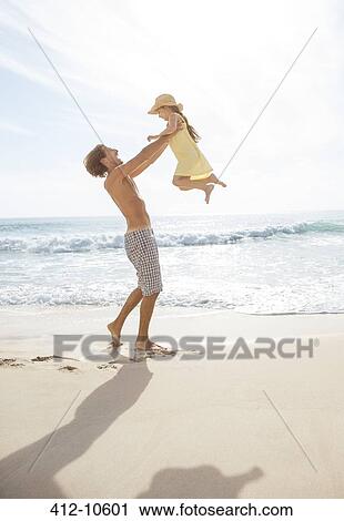 Father and daughter playing on beach View Large Photo Image Stock Image - Father and daughter playing on beach. Fotosearch