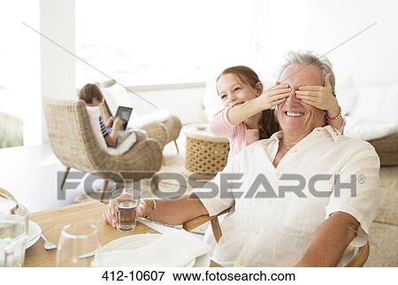 Girl covering grandfathers eyes View Large Photo Image Stock Photo - Girl covering grandfathers eyes. Fotosearch