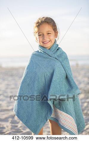 Girl wrapped in towel on beach View Large Photo Image Stock Photo - Girl wrapped in towel on beach. Fotosearch