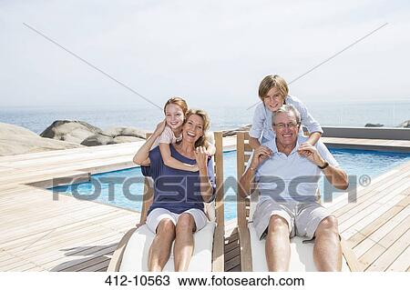 Grandchildren hugging grandparents at poolside View Large Photo Image Stock Image - Grandchildren hugging grandparents at poolside. Fotosearch