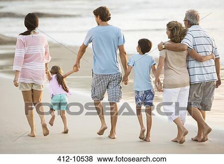 Multi-generation family holding hands on beach View Large Photo Image Stock Photo - Multi-generation family holding hands on beach. Fotosearch