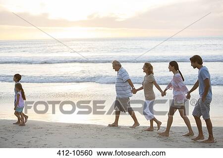 Multi-generation family walking on beach View Large Photo Image Stock Image - Multi-generation family walking on beach. Fotosearch