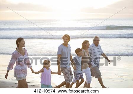 Multi-generation family walking together on beach View Large Photo Image Picture - Multi-generation family walking together on beach. Fotosearch