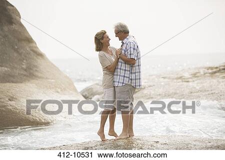 Senior couple hugging on beach View Large Photo Image Stock Image - Senior couple hugging on beach. Fotosearch