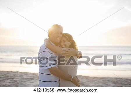 Senior couple hugging on beach View Large Photo Image Stock Photo - Senior couple hugging on beach. Fotosearch