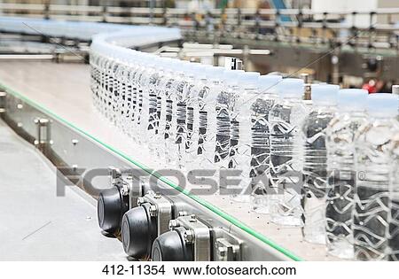 Bottles on conveyor belt in factory View Large Photo Image Picture - Bottles on conveyor belt in factory. Fotosearch