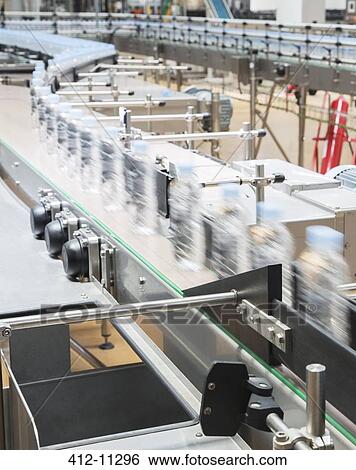Bottles on conveyor belt in factory View Large Photo Image Stock Photograph - Bottles on conveyor belt in factory. Fotosearch