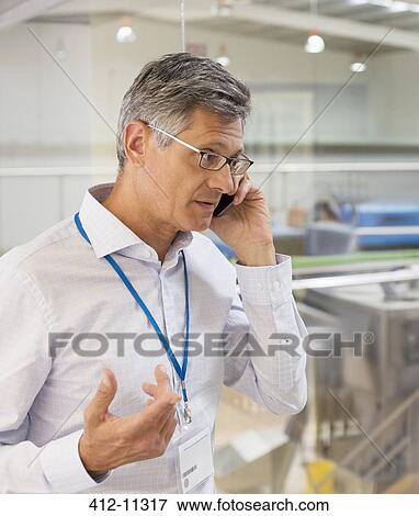 Stock Photo - Businessman talking on cell phone. Fotosearch