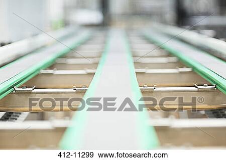 Close up of conveyor belt in factory View Large Photo Image Stock Photo - Close up of conveyor belt in factory. Fotosearch