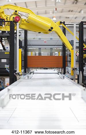 Stock Photo - Robotic machinery in factory. Fotosearch
