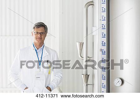 Scientist smiling in food processing plant View Large Photo Image Stock Image - Scientist smiling in food processing plant. Fotosearch