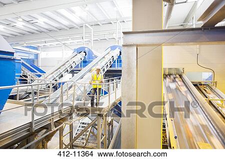 Worker on platform in recycling center View Large Photo Image Picture - Worker on platform in recycling center. Fotosearch