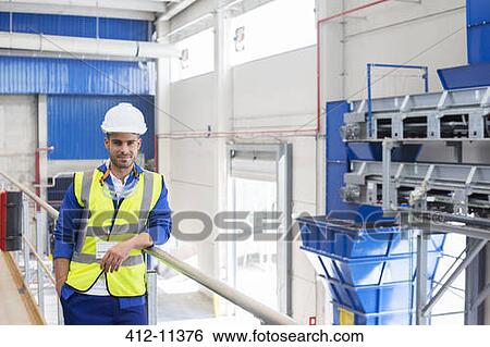 Stock Photograph - Worker smiling in factory. Fotosearch