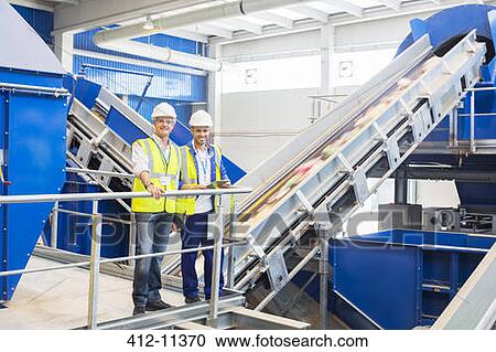 Workers smiling in recycling center View Large Photo Image Stock Image - Workers smiling in recycling center. Fotosearch