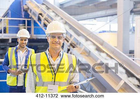 Workers smiling in recycling center View Large Photo Image Stock Image - Workers smiling in recycling center. Fotosearch