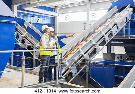 Workers talking in recycling center View Large Photo Image Picture - Workers talking in recycling center. Fotosearch