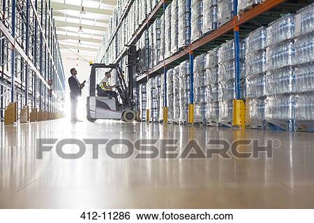 Workers with forklift in bottling warehouse View Large Photo Image Stock Photograph - Workers with forklift in bottling warehouse. Fotosearch
