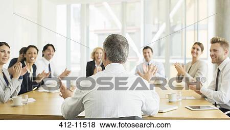 Stock Photo - Business people clapping in meeting. Fotosearch
