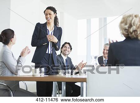 Stock Photograph - Business people clapping in meeting. Fotosearch