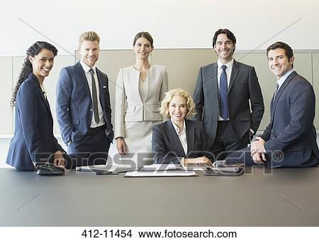Business people smiling in conference room View Large Photo Image Picture - Business people smiling in conference room. Fotosearch