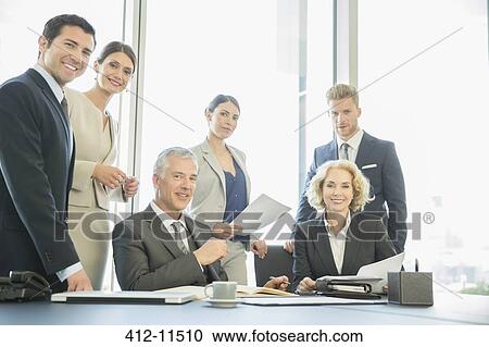 Business people smiling in meeting View Large Photo Image Stock Image - Business people smiling in meeting. Fotosearch