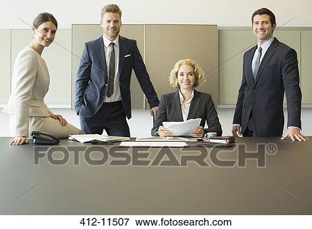 Business people smiling in meeting View Large Photo Image Stock Photo - Business people smiling in meeting. Fotosearch