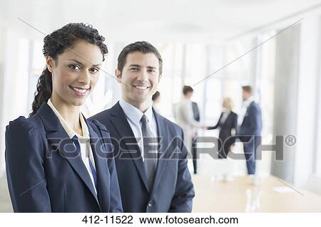 Business people smiling in office View Large Photo Image Stock Image - Business people smiling in office. Fotosearch