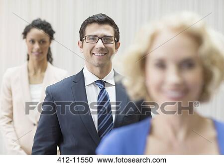 Business people smiling in office View Large Photo Image Stock Image - Business people smiling in office. Fotosearch