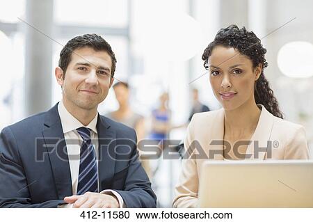 Business people smiling in office View Large Photo Image Stock Image - Business people smiling in office. Fotosearch