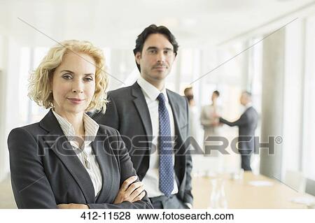 Business people standing in office View Large Photo Image Stock Photo - Business people standing in office. Fotosearch